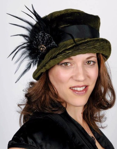 Model wearing Cohen in Olive Upholstery Fabric with Feather and Interconnected Fabric Bow | Handmade By Pandemonium  Millinery | Seattle WA USA