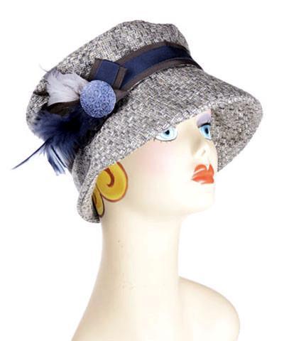 Woman wearing Molly Bucket Style Hat in Frozen Tundra Upholstery fabric  with  Blue Steel and Natural feather Brooch featuring a hand painted Blue Button | Handmade By Pandemonium Millinery in Seattle WA USA