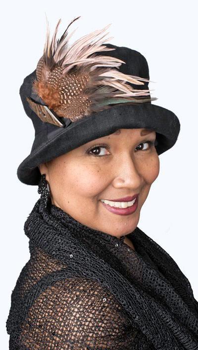 Model is wearing a Molly Hat Linen in Black with Black Band. The hat features Black and Pink feathers with  a button trim by Pandemonium Milllinery. Handmade in Seattle, WA.