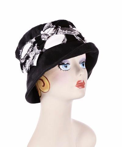 Model is wearing Molly Hat Linen in Black with Braided Band and  Steel and Plum feathers by Pandemonium Milllinery. Handmade in Seattle, WA.