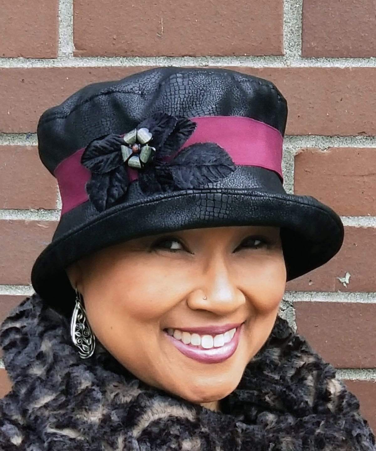 Woman wearing Molly Bucket Style Hat Vegan Leather in Outback Black with Velvet leaves and Floral Button Brooch | Pandemonium Millinery | Seattle WA