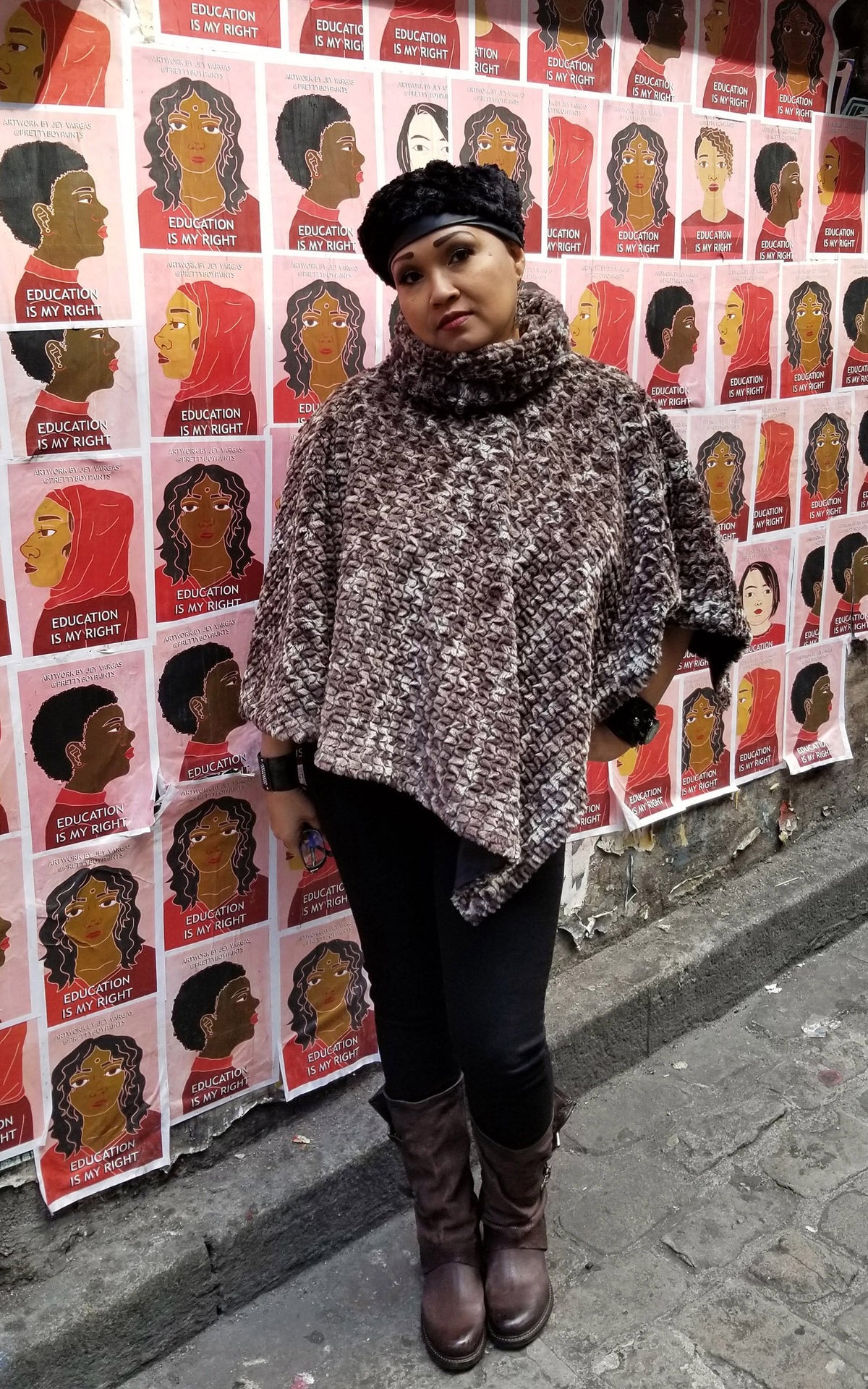 Model standing next to a wall of Flyers wearing a Satin Lined Poncho | Calico Brown and cream Faux Fur | Handmade Seattle WA USA by Pandemonium Millinery