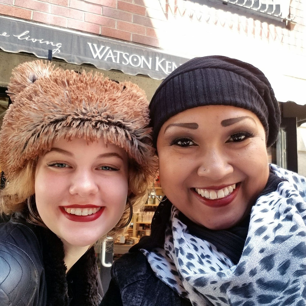 Woman in Shown in Black Voile Rowdie Hat with another Woman in Red Fox Bear Beanie | Handmade by Pandemonium Seattle
