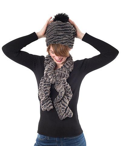 Women looking down and holding her reversible beanie hat with pom pom and Scrunchy Scarf | Desert Sand in Charcoal embossed faux fur with light and dark grays | Handmade in Seattle WA | Pandemonium Millinery