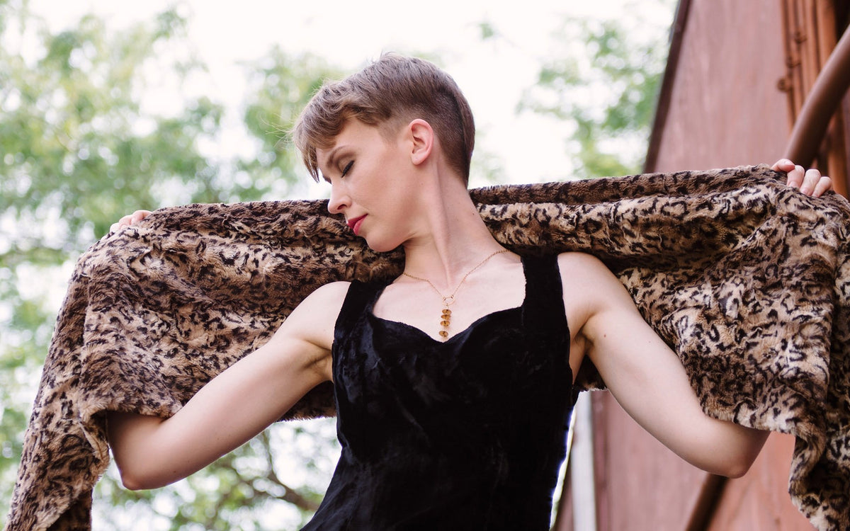 Woman spreading arms out holding  Stole behind her shoulders | Stole in Carpathian Lynx Animal Print Faux Fur | Handmade in Seattle WA | Pandemonium Millinery