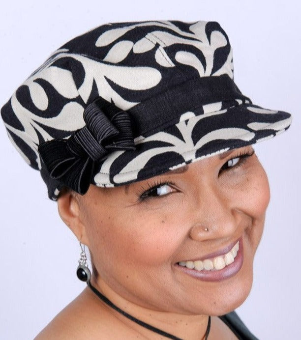 Woman wearing Valerie Cap Style | Black Pepper Paisley Upholstery Fabric | Satin Bow Trim with Black Linen Band | Handmade in Seattle WA USA |Pandemonium Millinery |