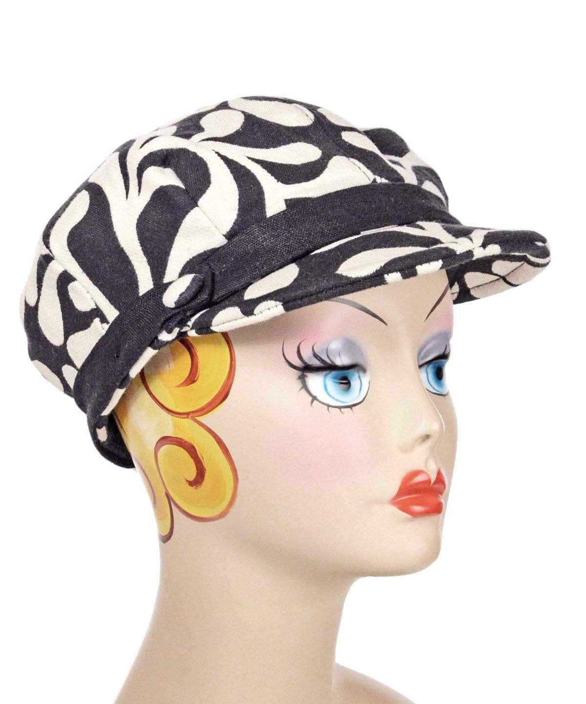 Woman wearing Valerie Cap Style | Black Pepper Paisley Upholstery Fabric | Satin Bow Trim with Black Linen Band | Handmade in Seattle WA USA |Pandemonium Millinery |