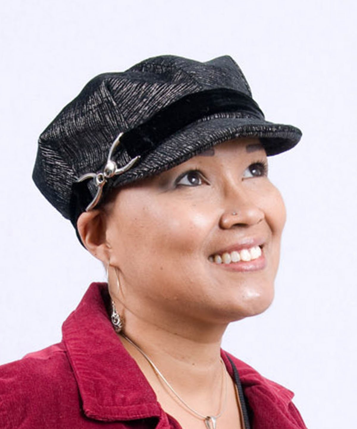 Woman wearing Valerie Cap Style | Bongo Black Beige Upholstery Fabric| Silver Buckle Trim  with Black Velvet Band | Handmade in Seattle WA USA |Pandemonium Millinery |