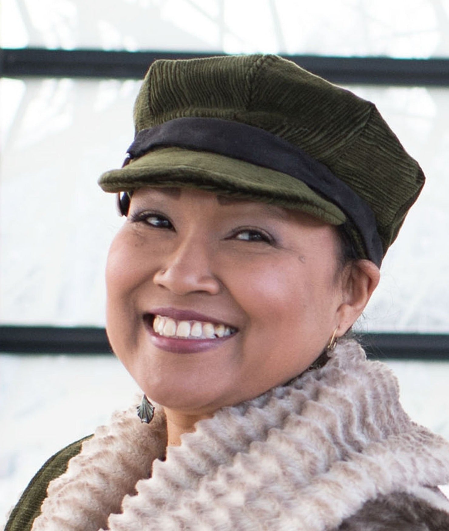 Model wearing Valerie Cap Style Hat with Black Band | Cohen in Olive Upholstery| Handmade by Pandemonium Millinery | Seattle WA