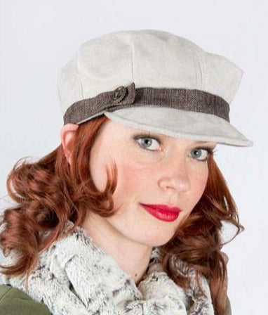 Woman wearing Valerie Cap in Silver Faux Suede with Origin Linen Band | Small Metal Button Trim | Handmade by Pandemonium Millinery | Seattle WA USA