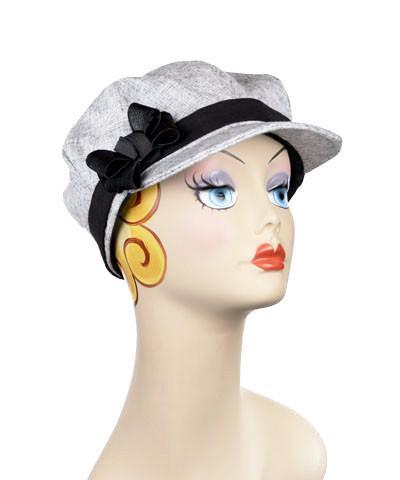 Woman wearing Valerie Cap in Metallic Silver Linen with Black Linen Band | Nickel Buckle Trim | Handmade by Pandemonium Millinery | Seattle WA USA