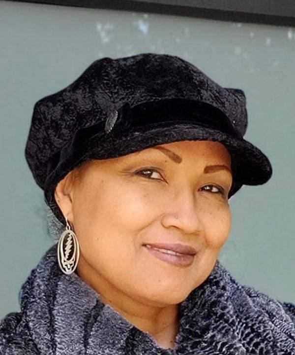 Model wearing a Valerie Cap Style  hat in Pebbles in Black with Black Velvet Band and Button handmade in Seattle, WA USA by Pandemonium Millinery.