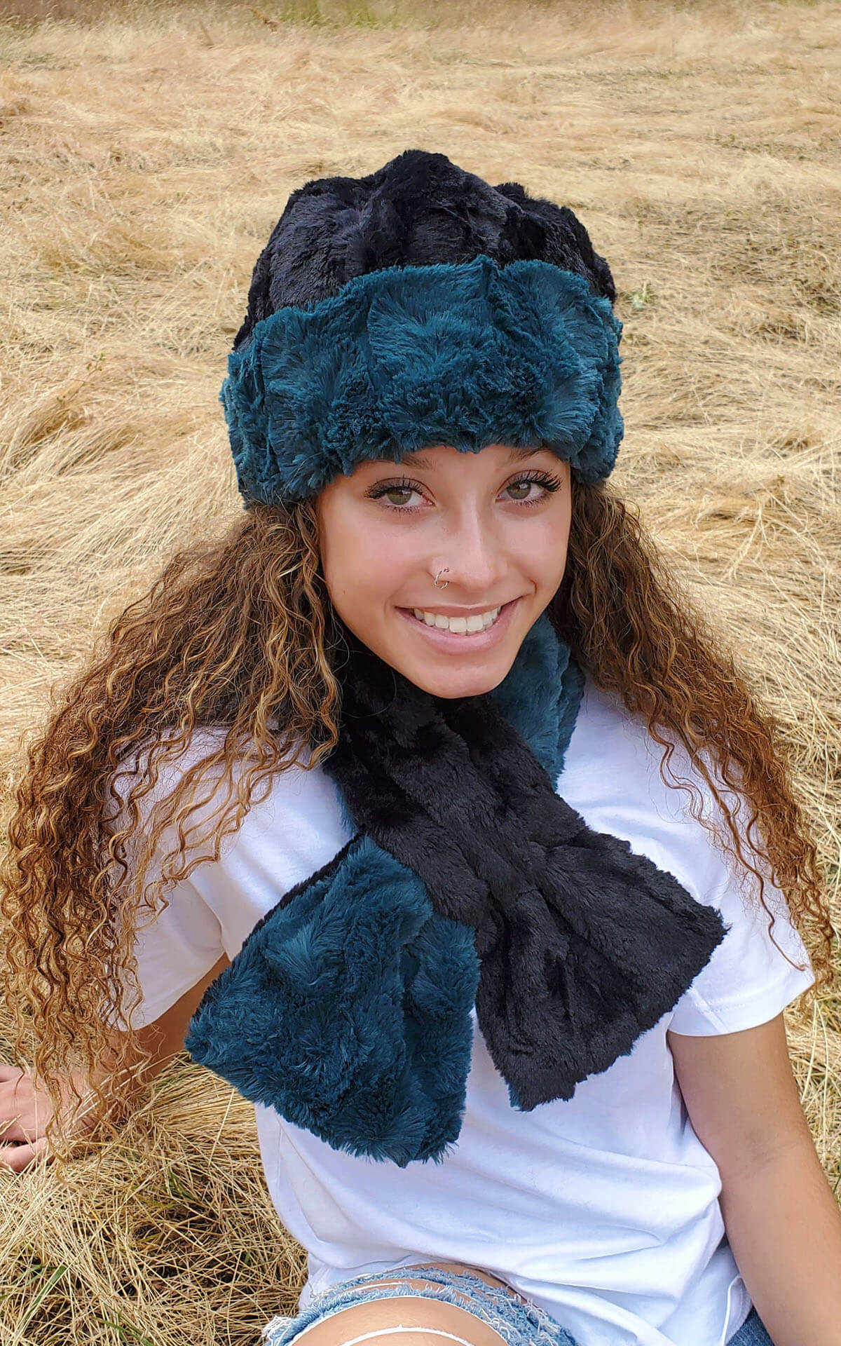 Model is wearing Women&#39;s Pull Through Scarf in Cuddly Fur in Peacock Pond with Cuddly Faux Fur in Black - reversible Handmade in Seattle
