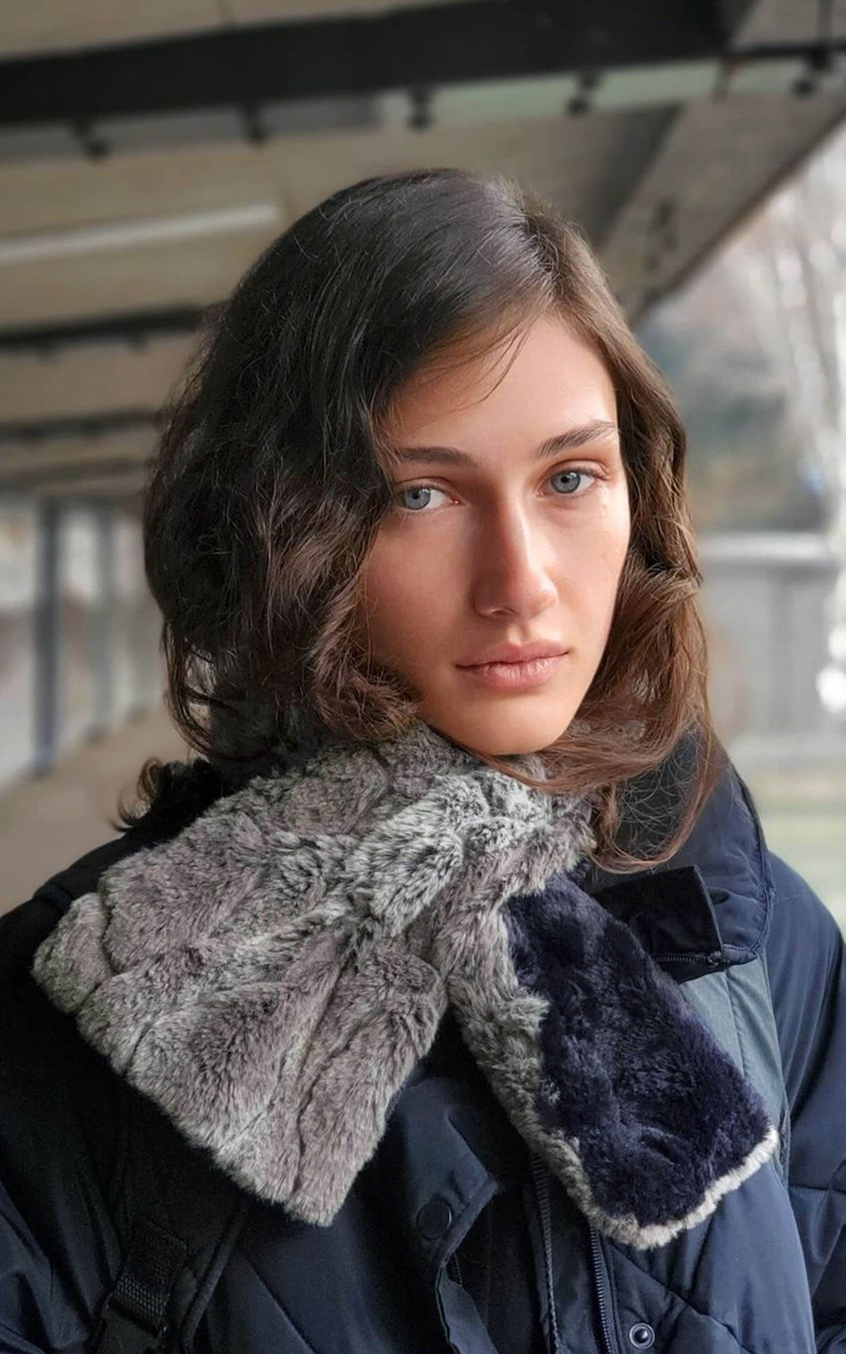 Model is wearing Women&#39;s Pull Through Scarf in Stormy Night with Cuddly Faux Fur in Black- reversible Handmade in Seattle