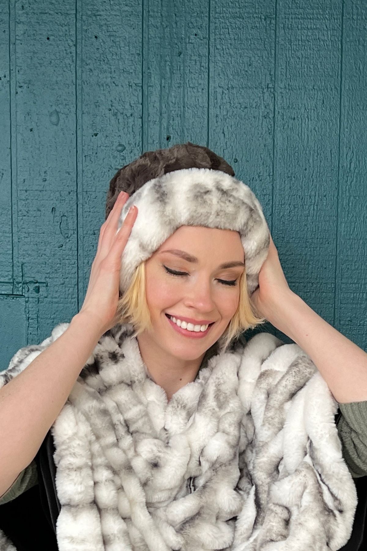 Woman wearing a Royal Opulence Cuffed Pillbox in Aspen with Cuddly Gray, and an Aspen Poncho. Handmade by Pandemonium Seattle.