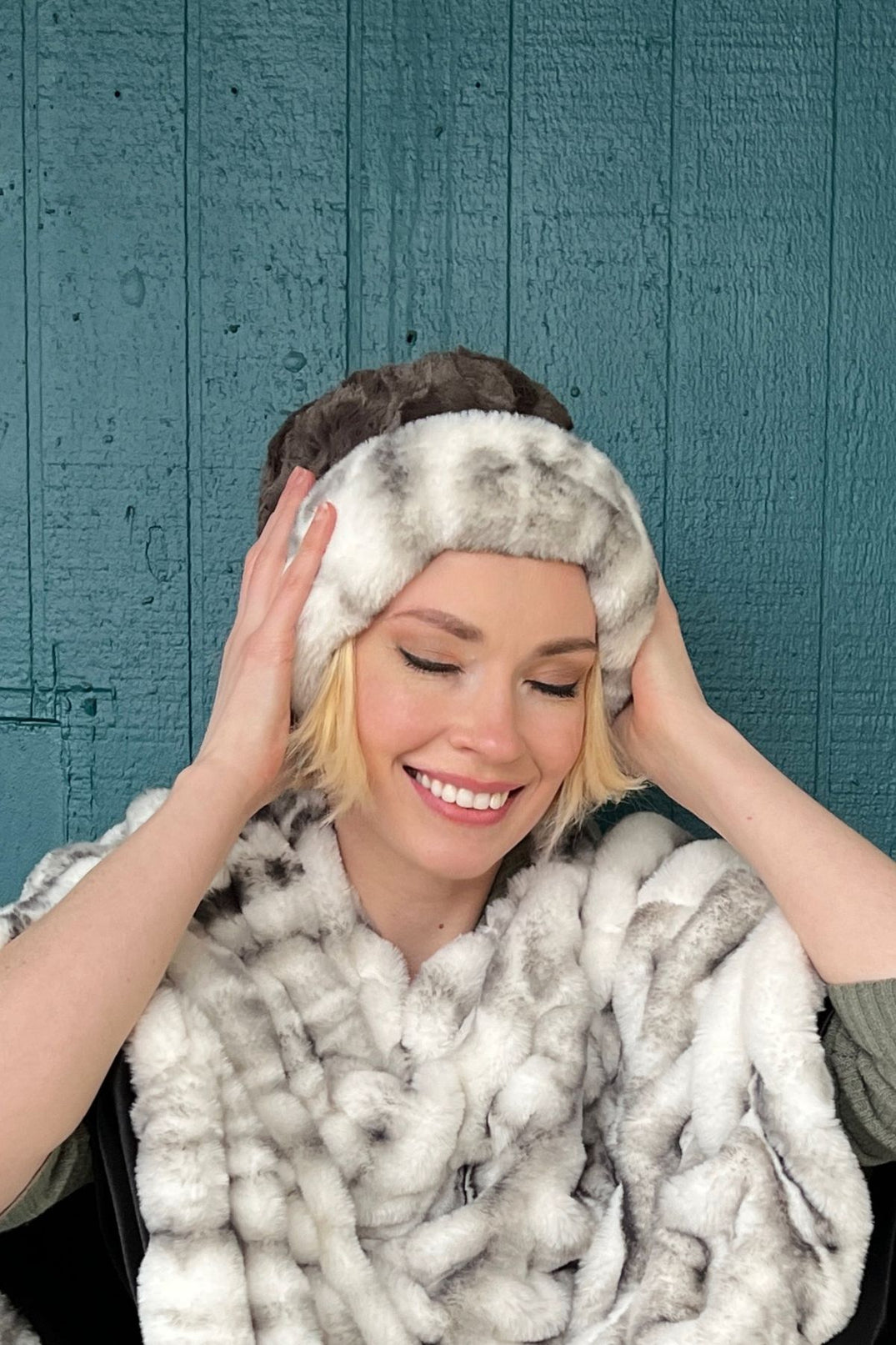 Woman wearing a Royal Opulence Cuffed Pillbox in Aspen with Cuddly Gray, and an Aspen Poncho. Handmade by Pandemonium Seattle.