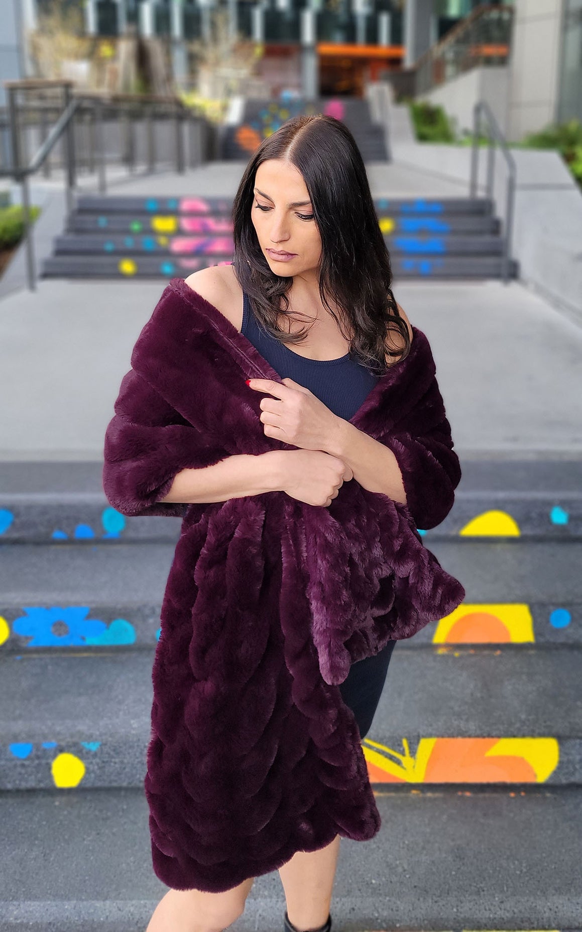 Woman wrapping herself in the Royal Opulence Stole in Merlot around her shoulders. Handmade by Pandemonium Seattle.