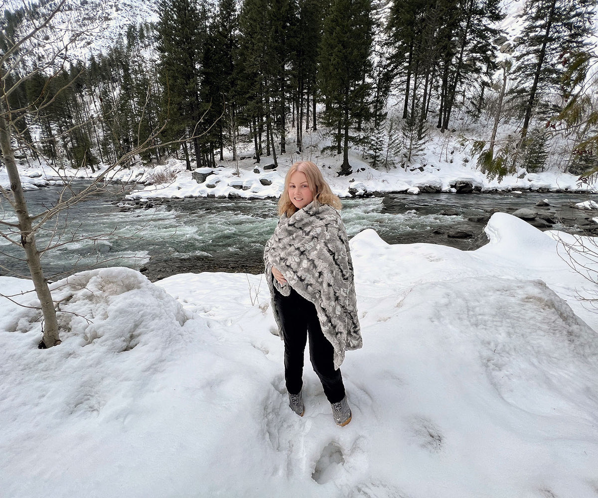 Throw Blanket on Model in front of river | White Water Luxury Faux Fur | Handmade in WA, USA by Pandemonium Seattle