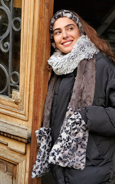 Women leaning against doorway wearing Color Tri-Color Pocket Scarf | Pearl Fox, Savannah Cat animal print and Cuddly Gray a  combo of blacks grays and cream, long and short hair Faux Fur | Handmade in Seattle WA Pandemonium Millinery