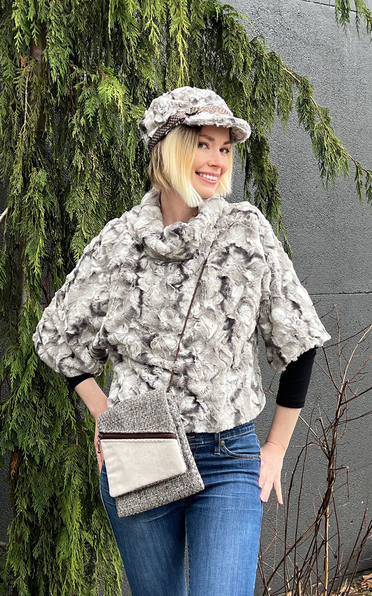 model in sweater top and matching hat in White Water Faux Fur  and Prague Handbag