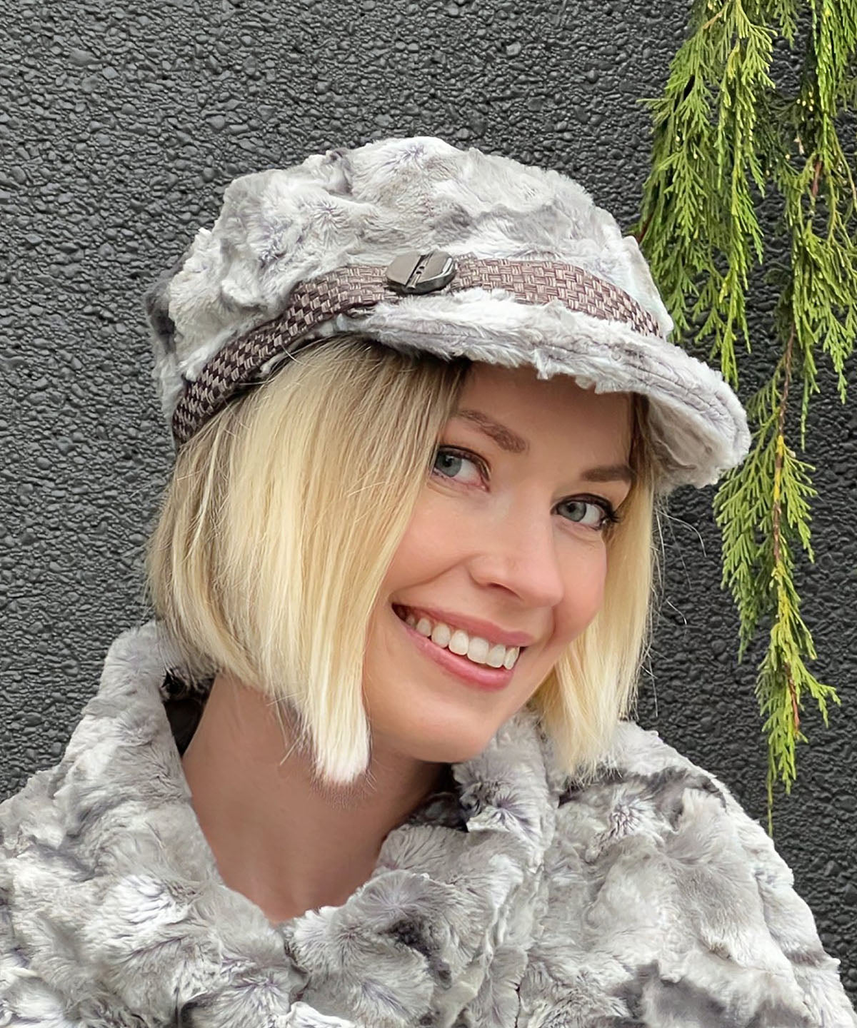 Model waring Valerie Cap in White Water Faux Fur with Interconnected in Java Hat band with  Button trim by Pandemonium Millinery. Handmade in Seattle WA, USA.